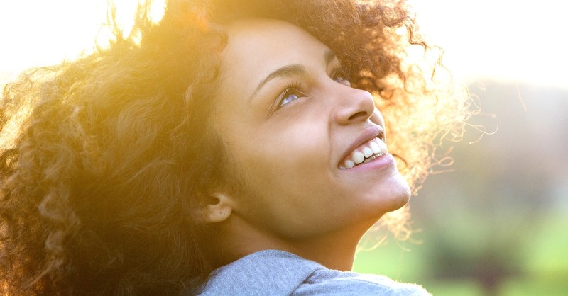 close up of woman looking up joyfully smiling, love my neighbor