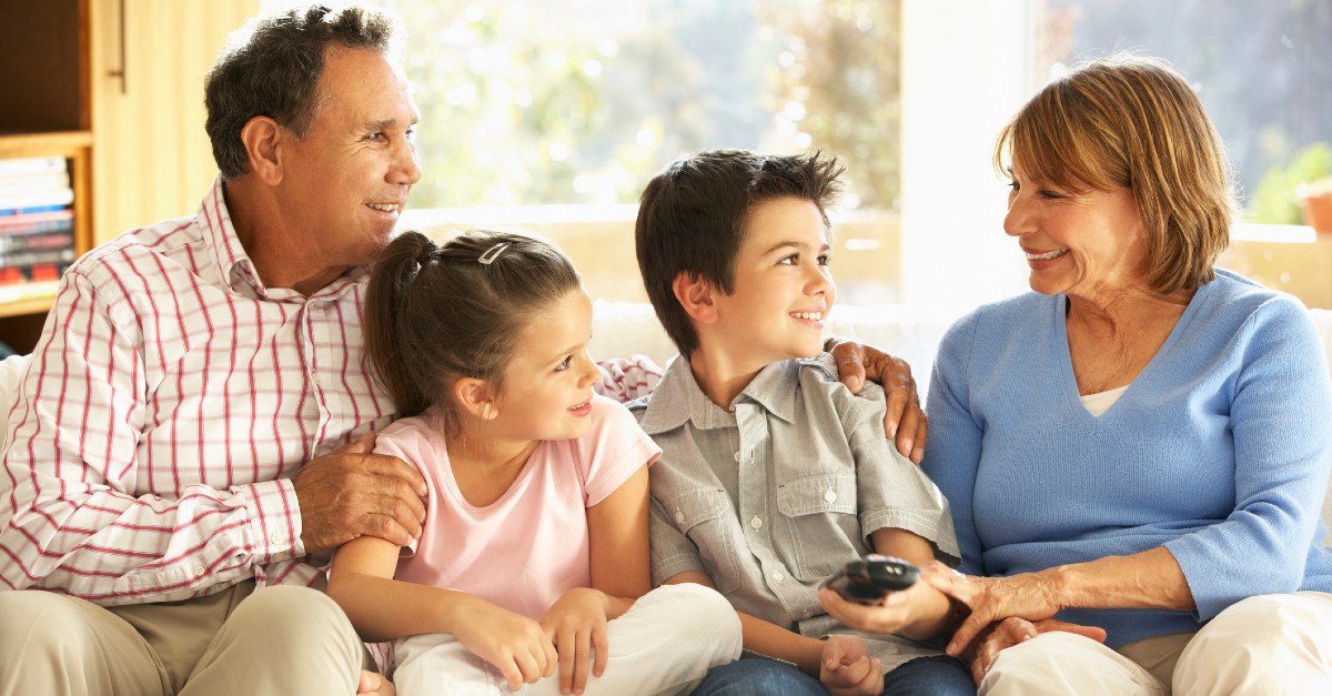 grandparents watching tv with family