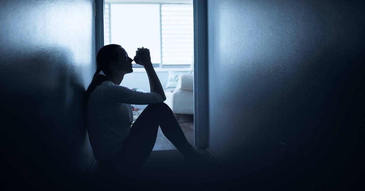 Woman praying in the dark