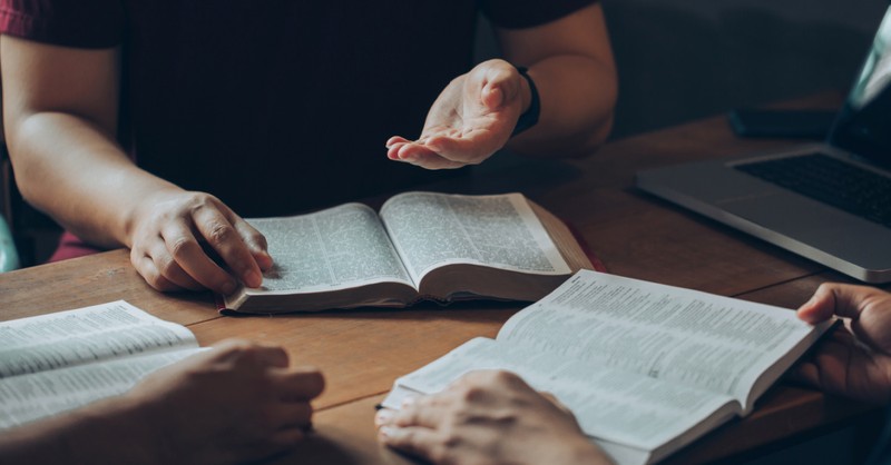 Group of adults studying the Bible together