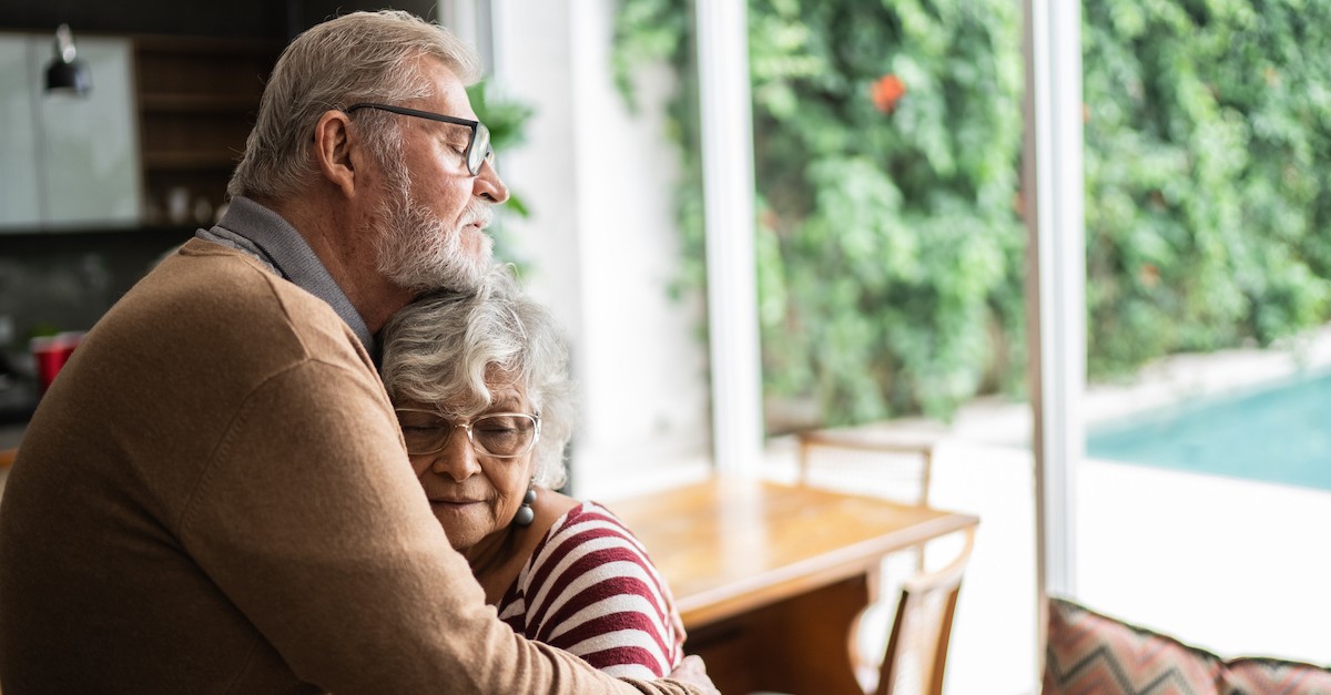 sad grandparents senior couple hugging