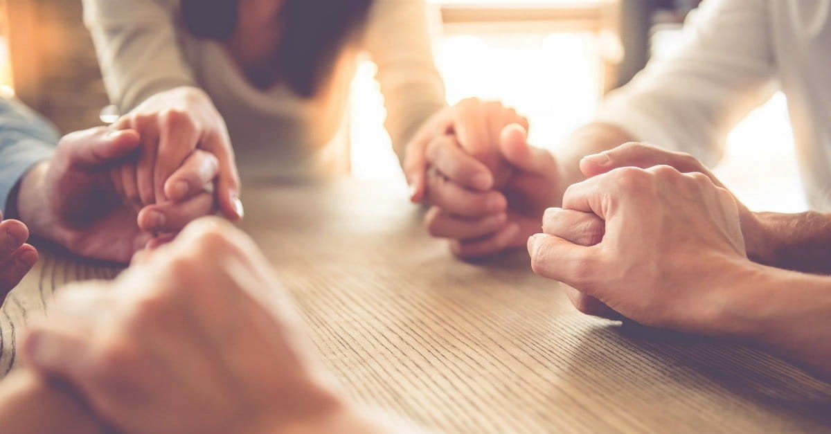 group holding hands praying, praying doesn't have to be hard