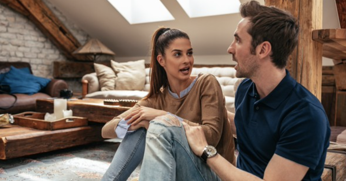 Couple talking sitting having serious conversation